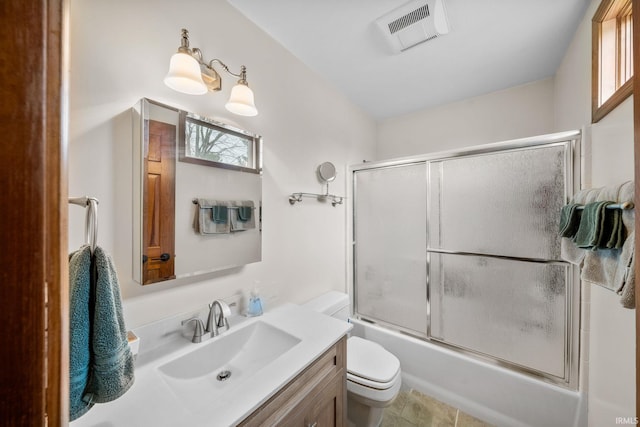 bathroom with a wealth of natural light, visible vents, vanity, and toilet