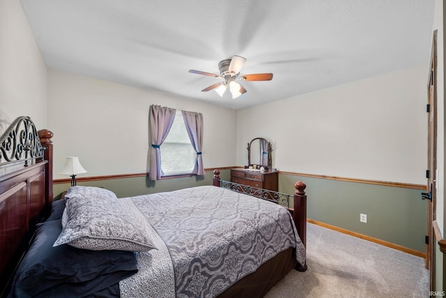 carpeted bedroom featuring ceiling fan and baseboards