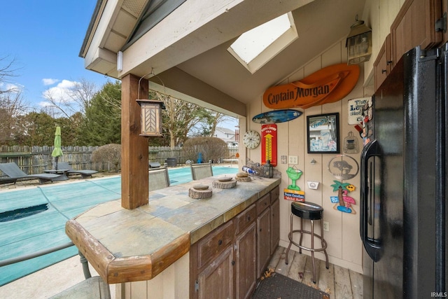 view of patio featuring fence and a fenced in pool