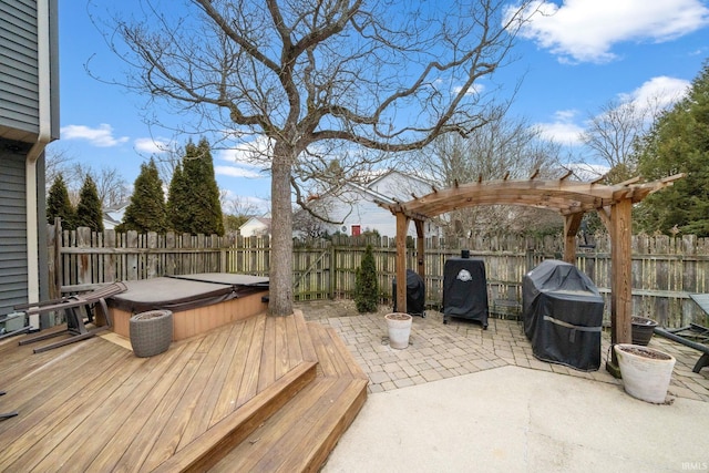 deck with a covered hot tub, grilling area, a patio area, a pergola, and a fenced backyard