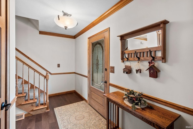 foyer with dark wood-style floors, baseboards, stairway, and ornamental molding