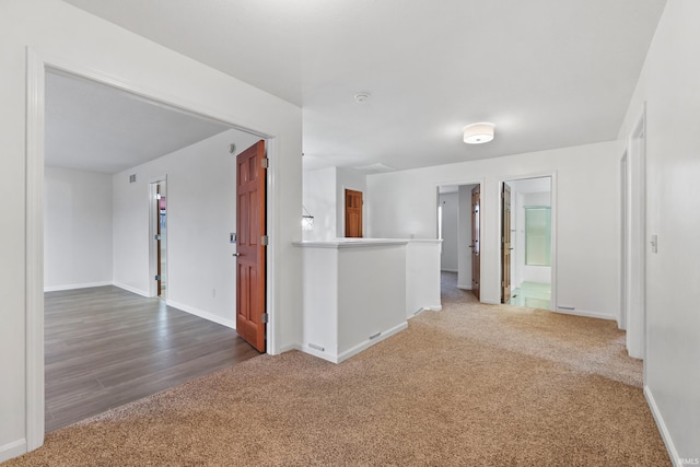 carpeted empty room featuring baseboards