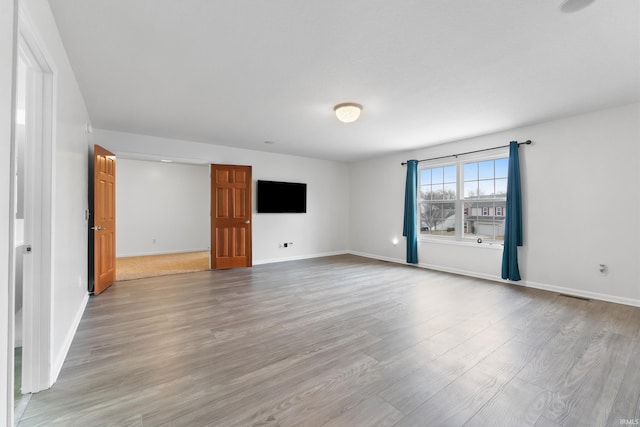 interior space featuring wood finished floors, visible vents, and baseboards