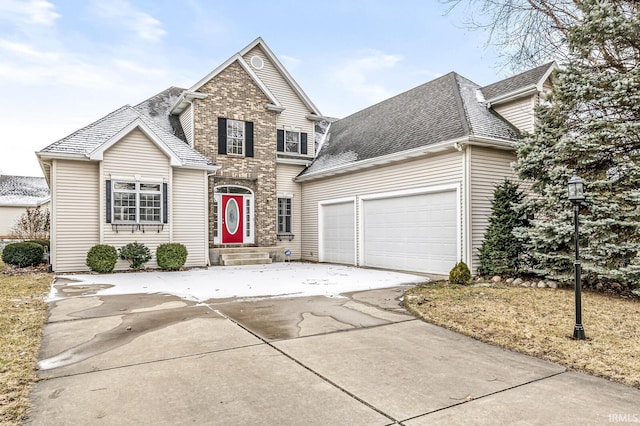 traditional-style home featuring roof with shingles, driveway, and an attached garage