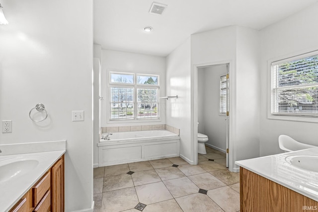 bathroom featuring visible vents, plenty of natural light, vanity, and toilet