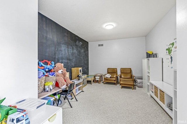 recreation room with carpet and visible vents