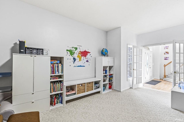 rec room with a healthy amount of sunlight, carpet, baseboards, and french doors