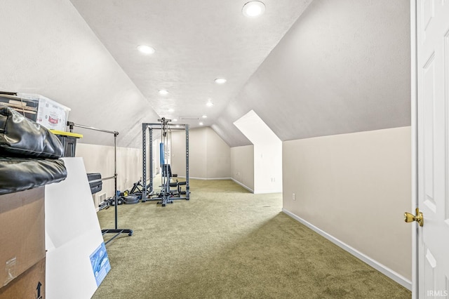 exercise room with lofted ceiling, carpet floors, recessed lighting, and baseboards