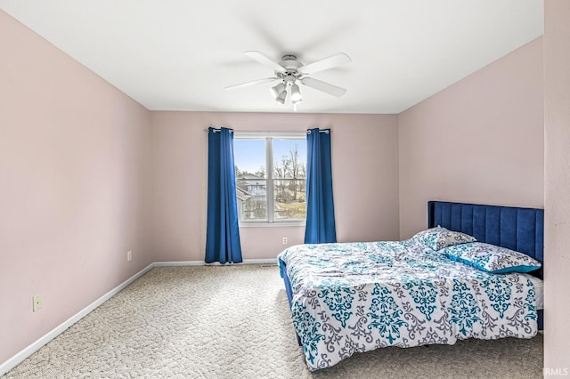 carpeted bedroom featuring a ceiling fan and baseboards