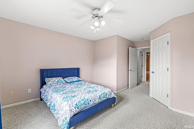 carpeted bedroom featuring ceiling fan and baseboards