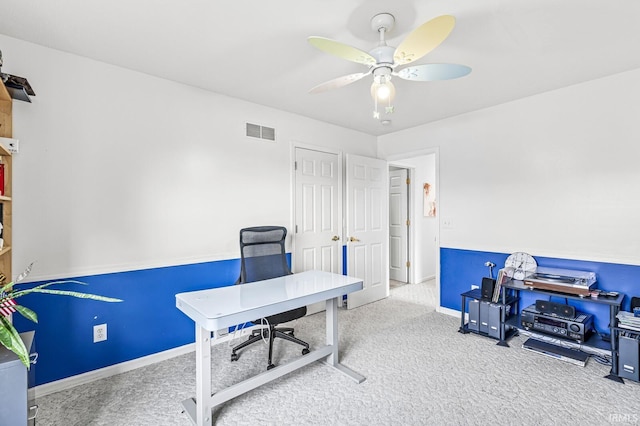 carpeted home office with visible vents, ceiling fan, and baseboards