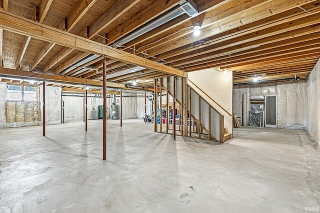 basement featuring stairway and gas water heater