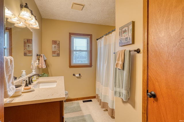 full bathroom featuring a textured ceiling, toilet, visible vents, vanity, and baseboards