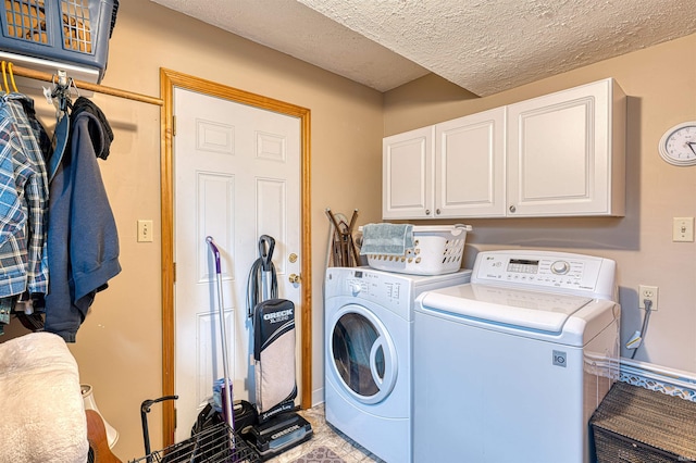 laundry area with washer and dryer, cabinet space, and a textured ceiling