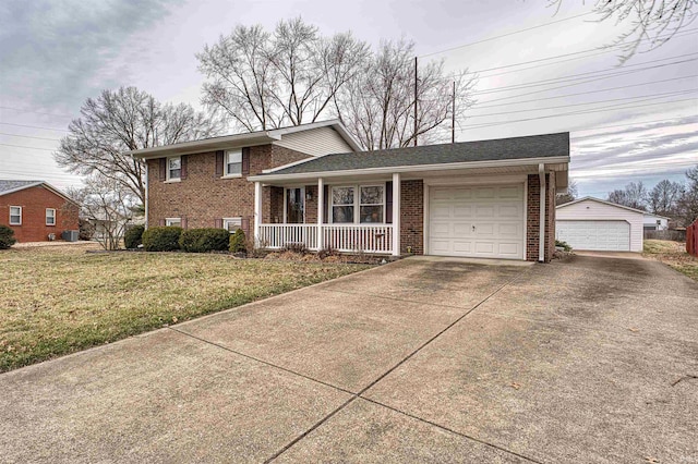 split level home featuring covered porch, brick siding, and a front lawn