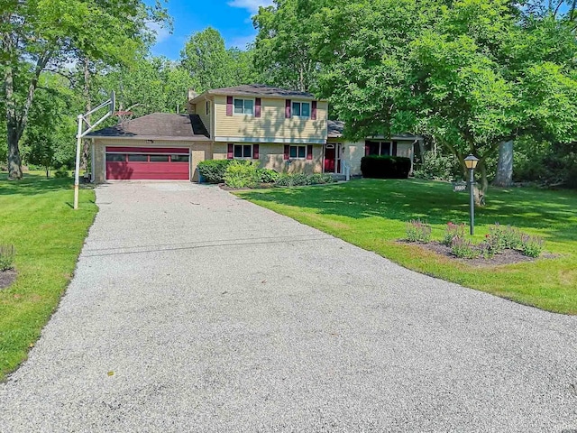 view of front of house with a garage, aphalt driveway, and a front yard