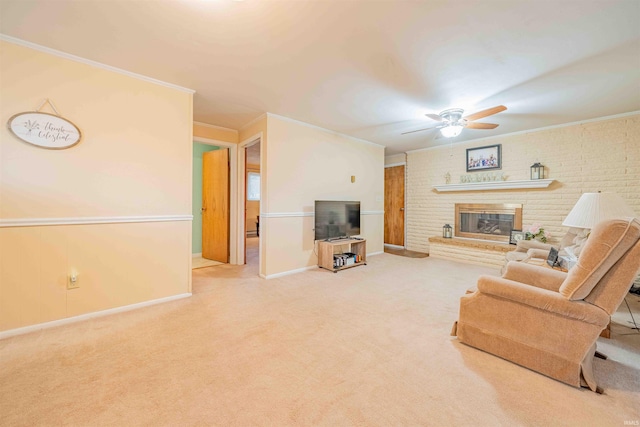 living area featuring a brick fireplace, carpet flooring, a ceiling fan, and crown molding