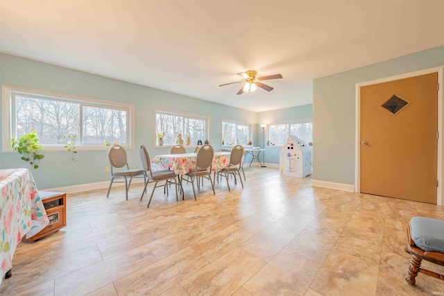 dining room with baseboards and a ceiling fan