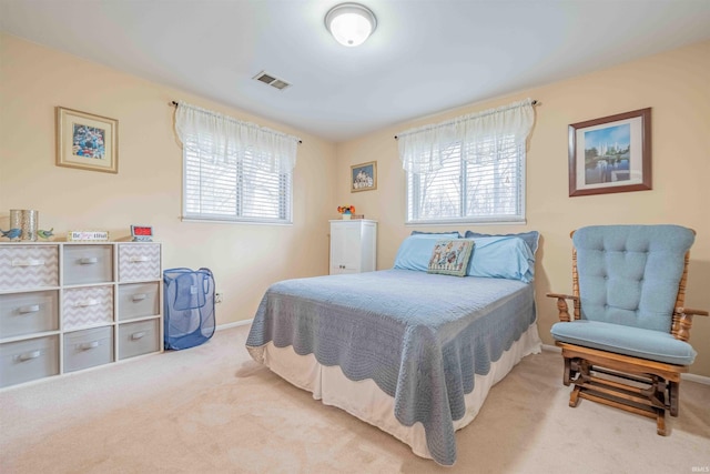 carpeted bedroom featuring baseboards, multiple windows, and visible vents