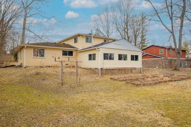 back of property with brick siding and a lawn