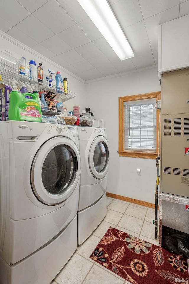 laundry room with laundry area, light tile patterned floors, baseboards, and separate washer and dryer