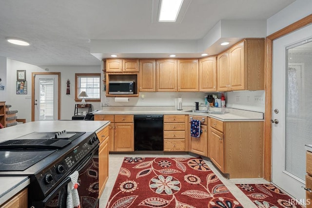 kitchen with light tile patterned flooring, light countertops, black appliances, a sink, and recessed lighting