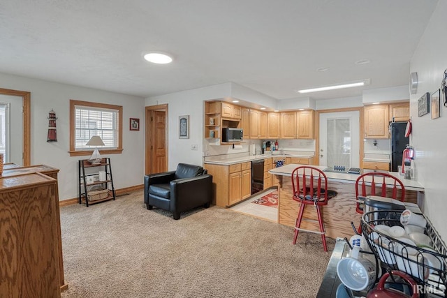 kitchen with open shelves, light countertops, freestanding refrigerator, light carpet, and baseboards