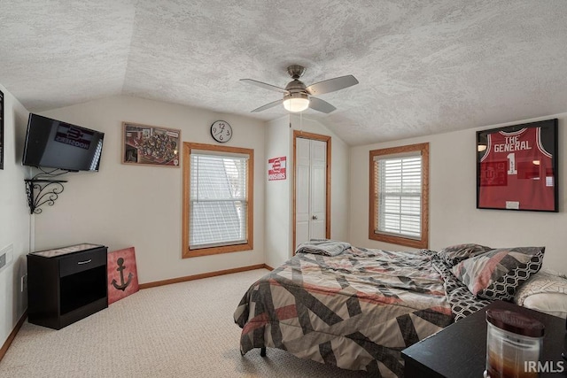 bedroom with vaulted ceiling, a textured ceiling, carpet flooring, and baseboards