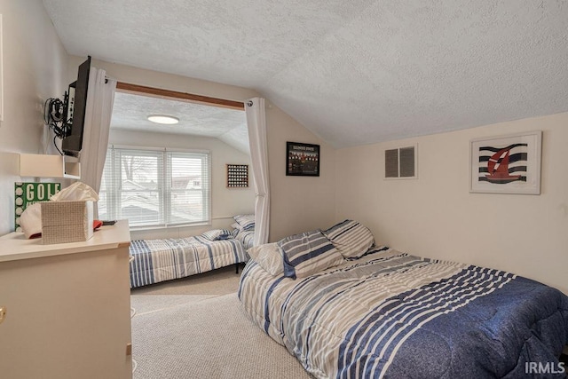 bedroom with a textured ceiling, carpet flooring, visible vents, and lofted ceiling