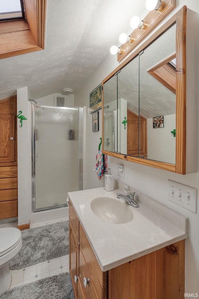 full bathroom featuring lofted ceiling, a stall shower, a textured ceiling, and vanity