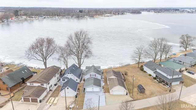 bird's eye view featuring a water view and a residential view