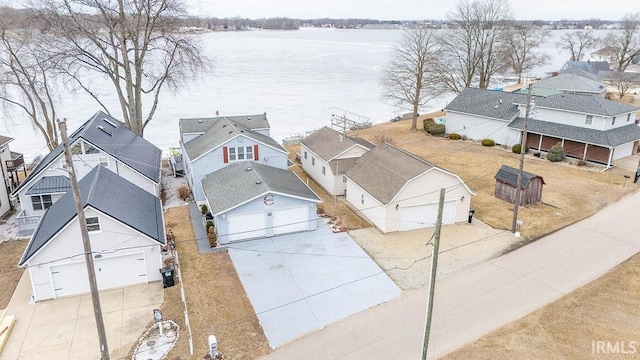 bird's eye view with a water view and a residential view