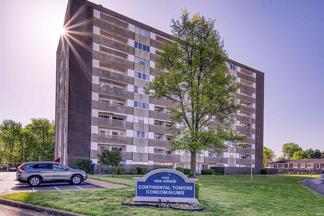 view of building exterior featuring uncovered parking