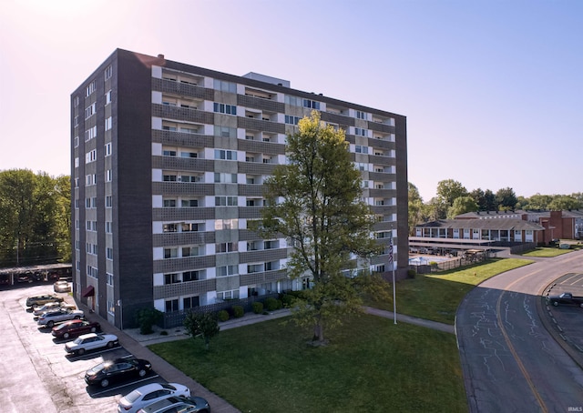 view of building exterior featuring uncovered parking