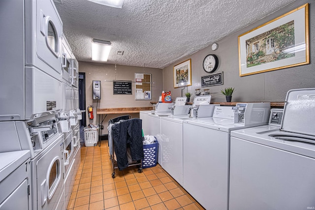 shared laundry area featuring stacked washer / drying machine, light tile patterned floors, a textured ceiling, and separate washer and dryer