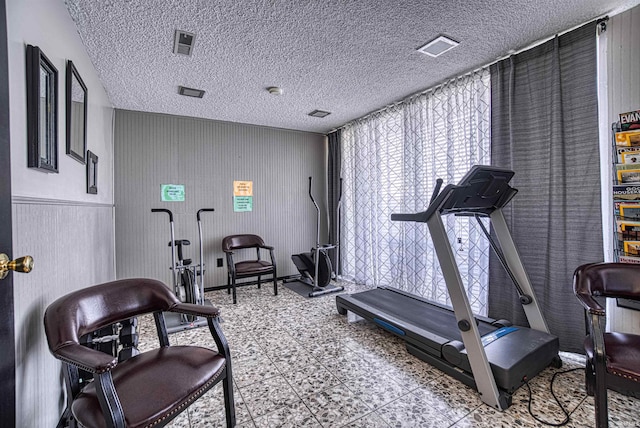 workout room with a textured ceiling