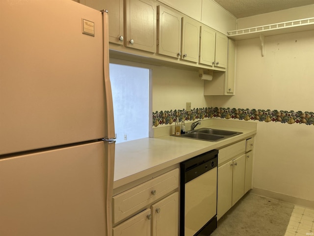 kitchen featuring light countertops, white appliances, a sink, and baseboards