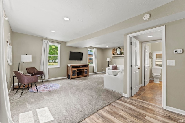 carpeted living room with baseboards, wood finished floors, and recessed lighting