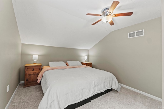 carpeted bedroom featuring a ceiling fan, visible vents, vaulted ceiling, and baseboards