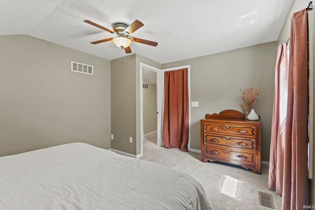 carpeted bedroom with lofted ceiling, visible vents, and baseboards