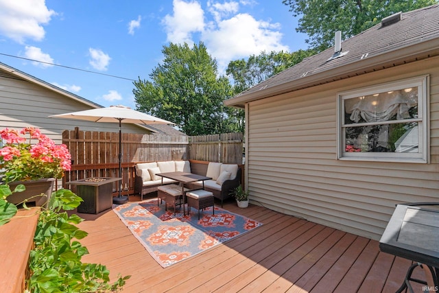 wooden deck featuring outdoor lounge area and fence