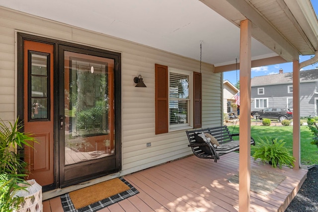 view of exterior entry featuring a porch