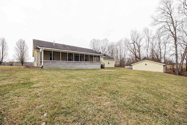 rear view of house featuring a lawn