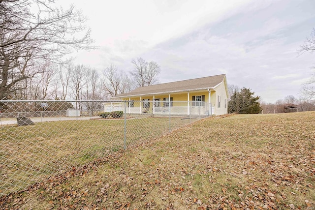 view of front of property with fence and a front lawn