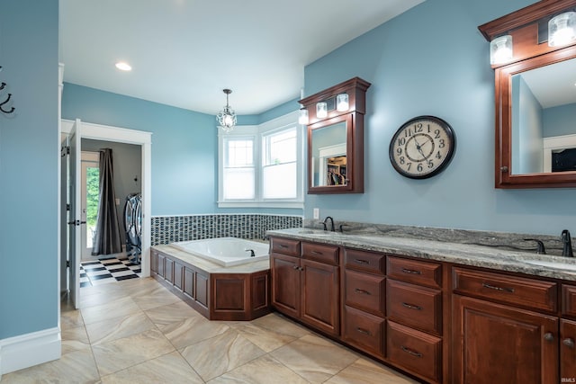 bathroom featuring a sink, a bath, and double vanity