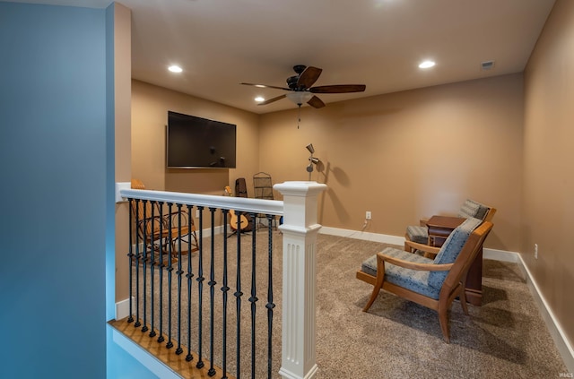 living area with recessed lighting, carpet flooring, visible vents, an upstairs landing, and baseboards