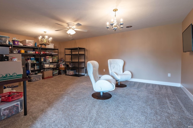 living area featuring baseboards, carpet flooring, and ceiling fan with notable chandelier