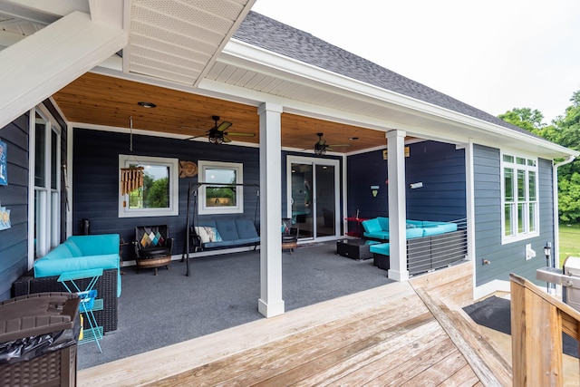 wooden terrace with ceiling fan and an outdoor hangout area