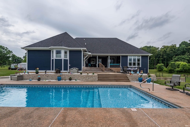 outdoor pool featuring a patio area, fence, and a wooden deck