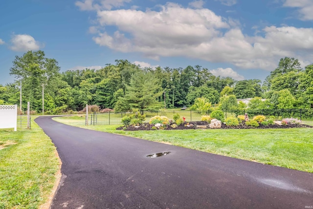 surrounding community with a yard and fence